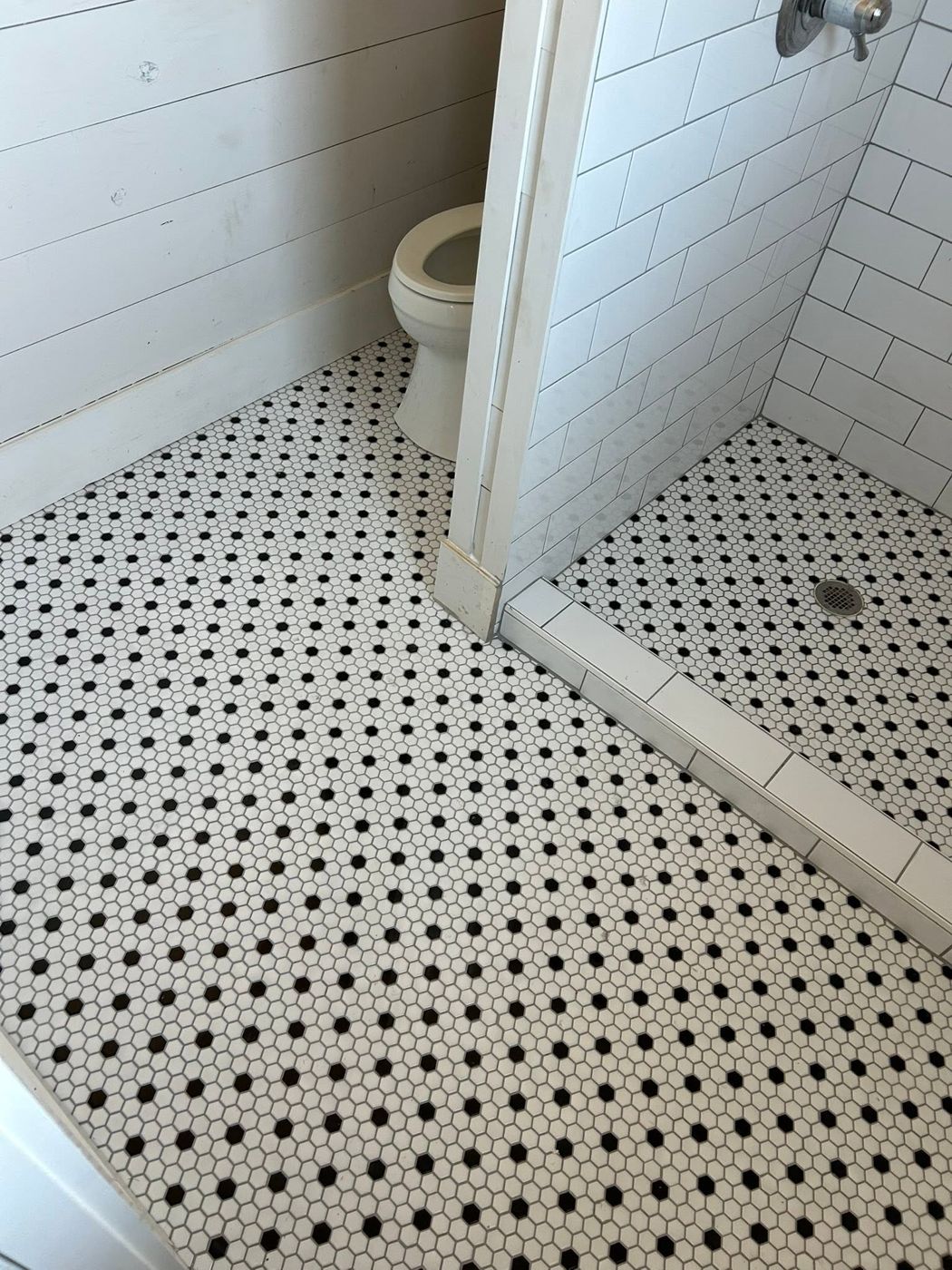 Hex Mosaic Floor: Penny-dot hex tile carried through the whole bathroom.