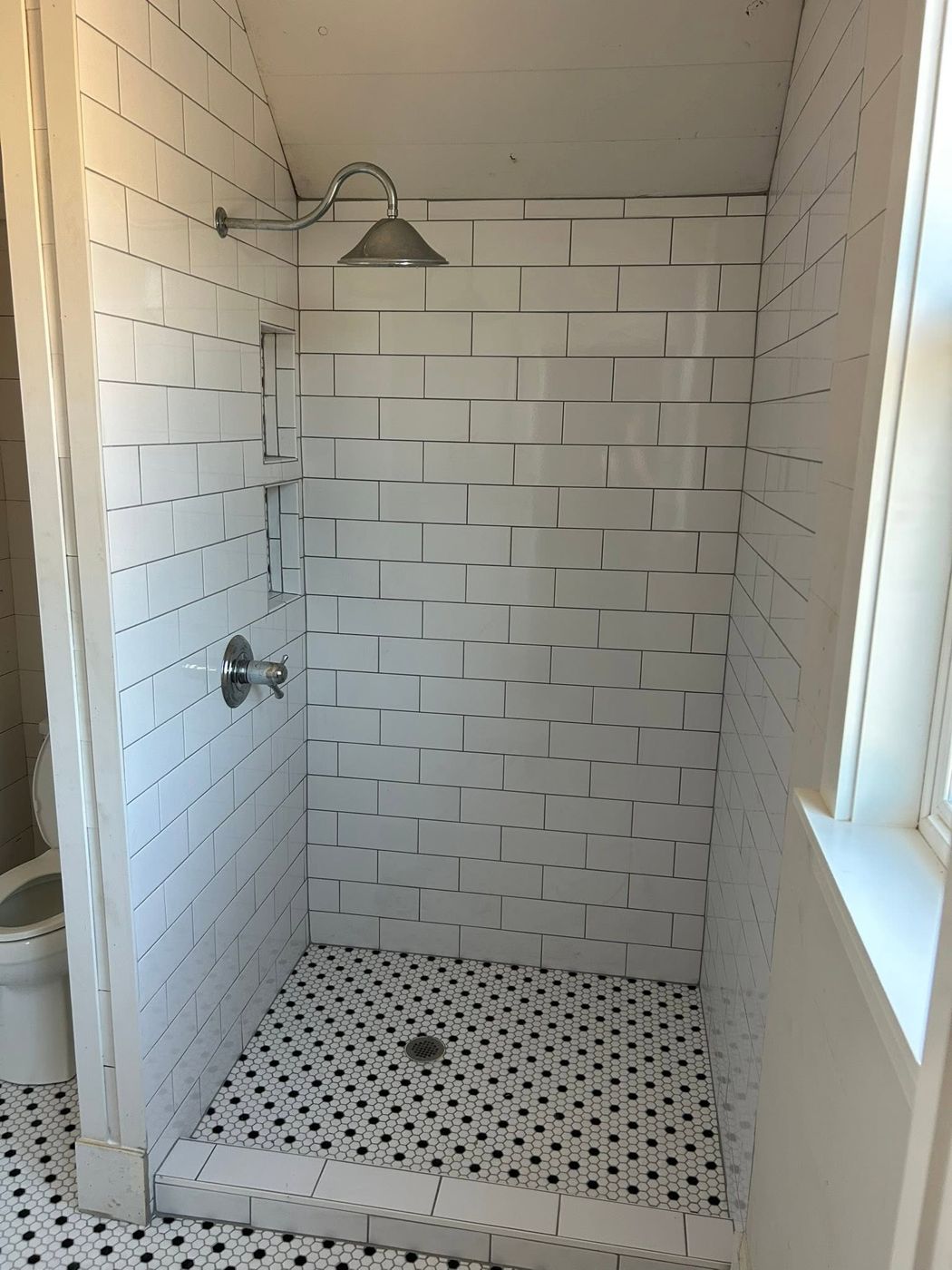 Walk-in Subway Tile Shower: White subway tile, built-in shelves and a hex mosaic floor.
