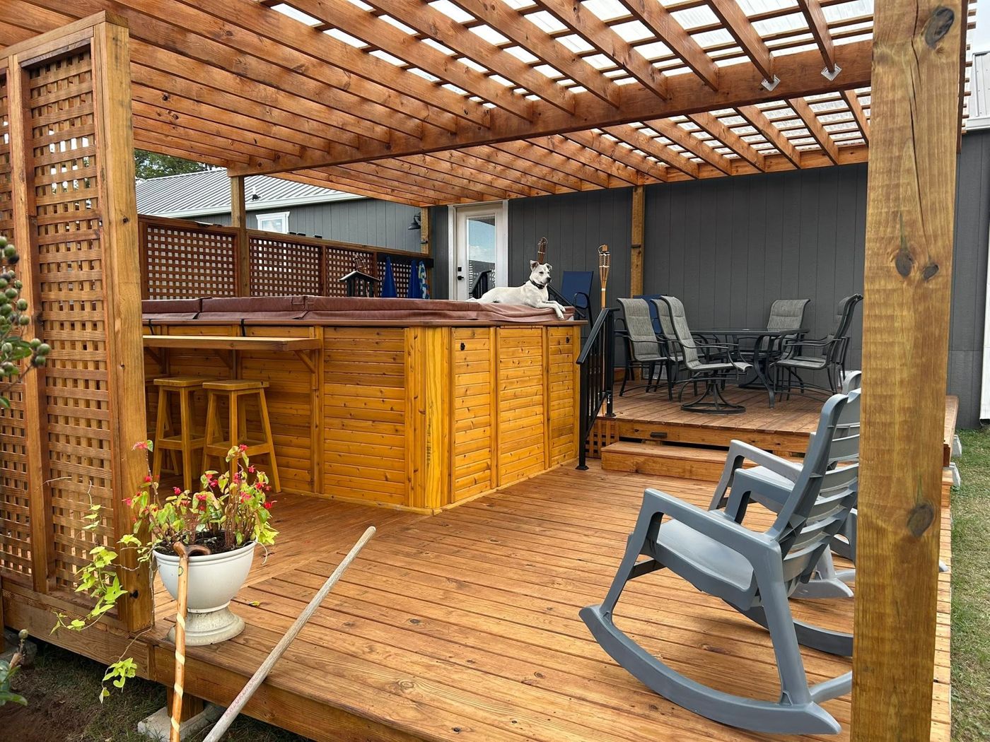 Pergola Over the Hot Tub: Shaded hot tub corner framed with lattice privacy walls.