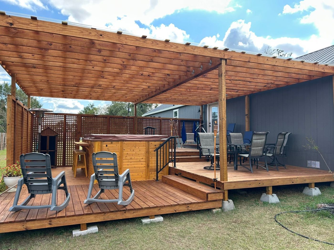 Backyard Deck & Pergola: Multi-level deck with pergola, hot tub surround and dining area.