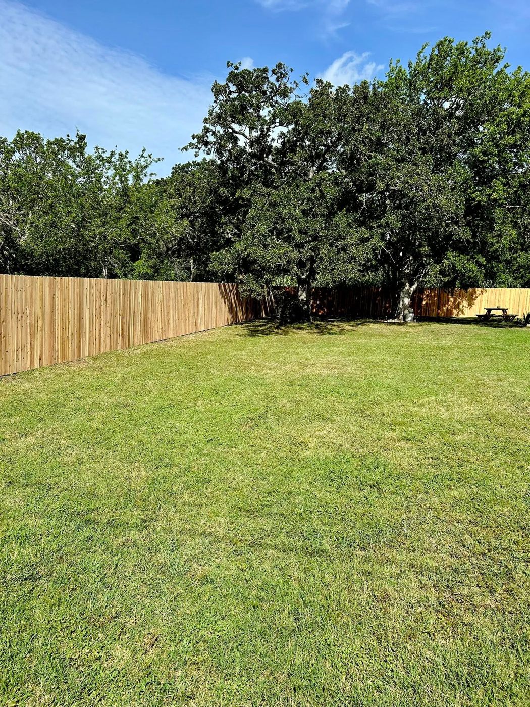 Backyard Fence: Full-length privacy fence enclosing a large back yard.