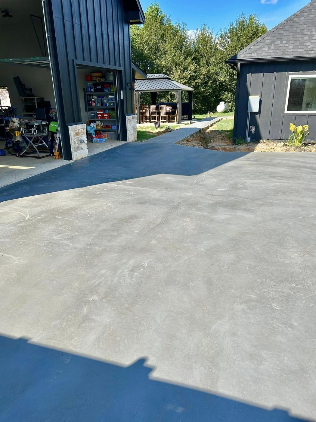 Concrete Driveway: New concrete driveway and walkway poured outside the finished shop.