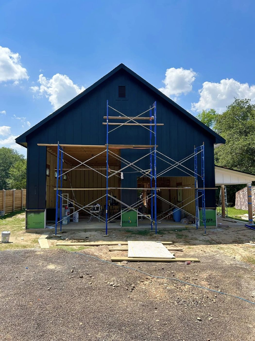 Shop Under Construction: The same garage mid-build, siding going up.