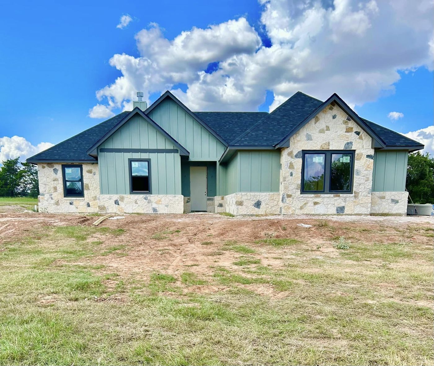 New Custom Home: Board-and-batten siding with stone accents, finished from the ground up.
