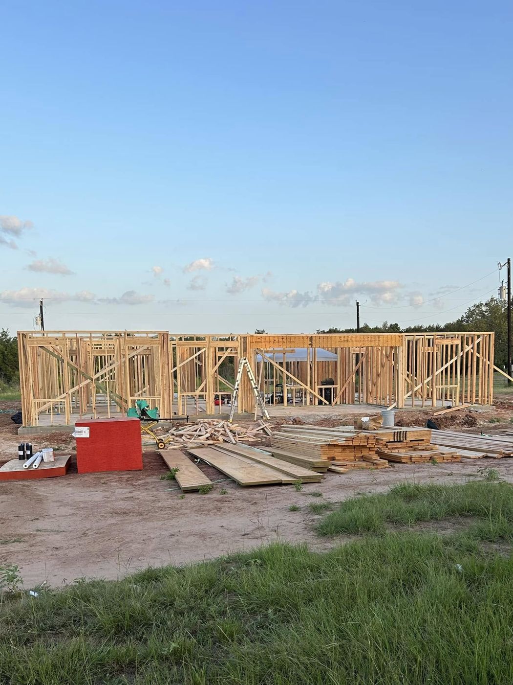 Framing Begins: Walls going up on the slab for a new custom home.